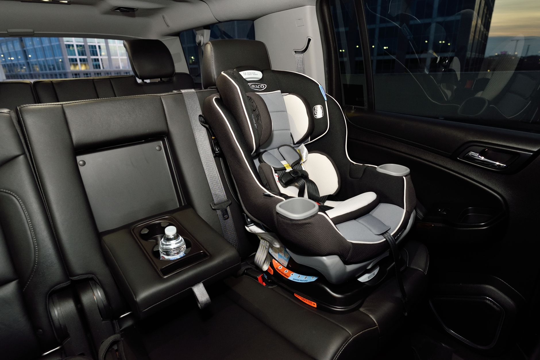 Safety car seat securely installed in the back of a modern vehicle. Ideal for family travel.