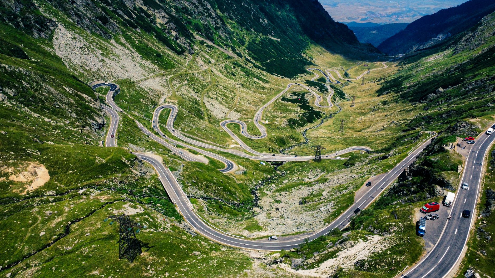 Aerial view of the scenic Transfăgărășan Highway weaving through the Carpathian Mountains in Romania.