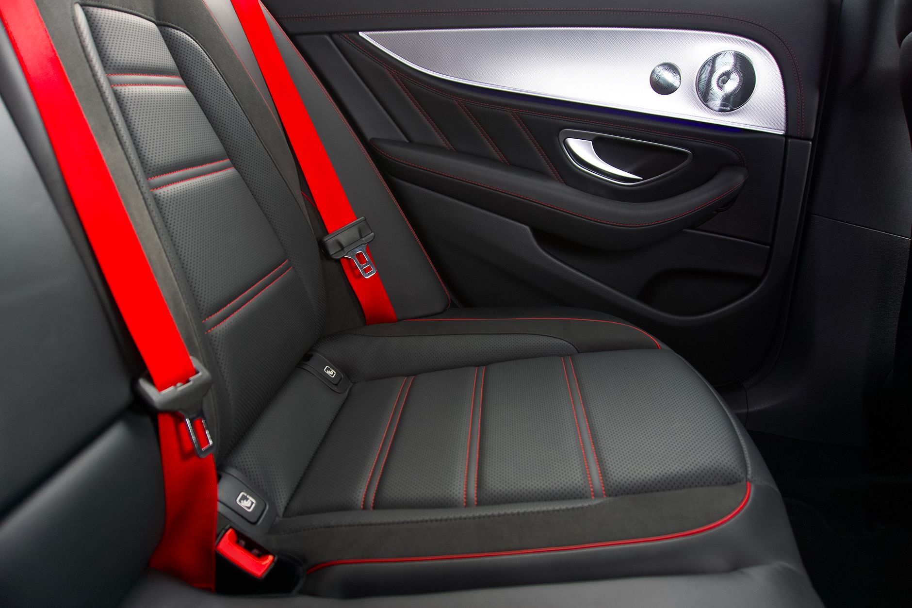 Sleek car interior featuring black and red seats with contemporary design elements.
