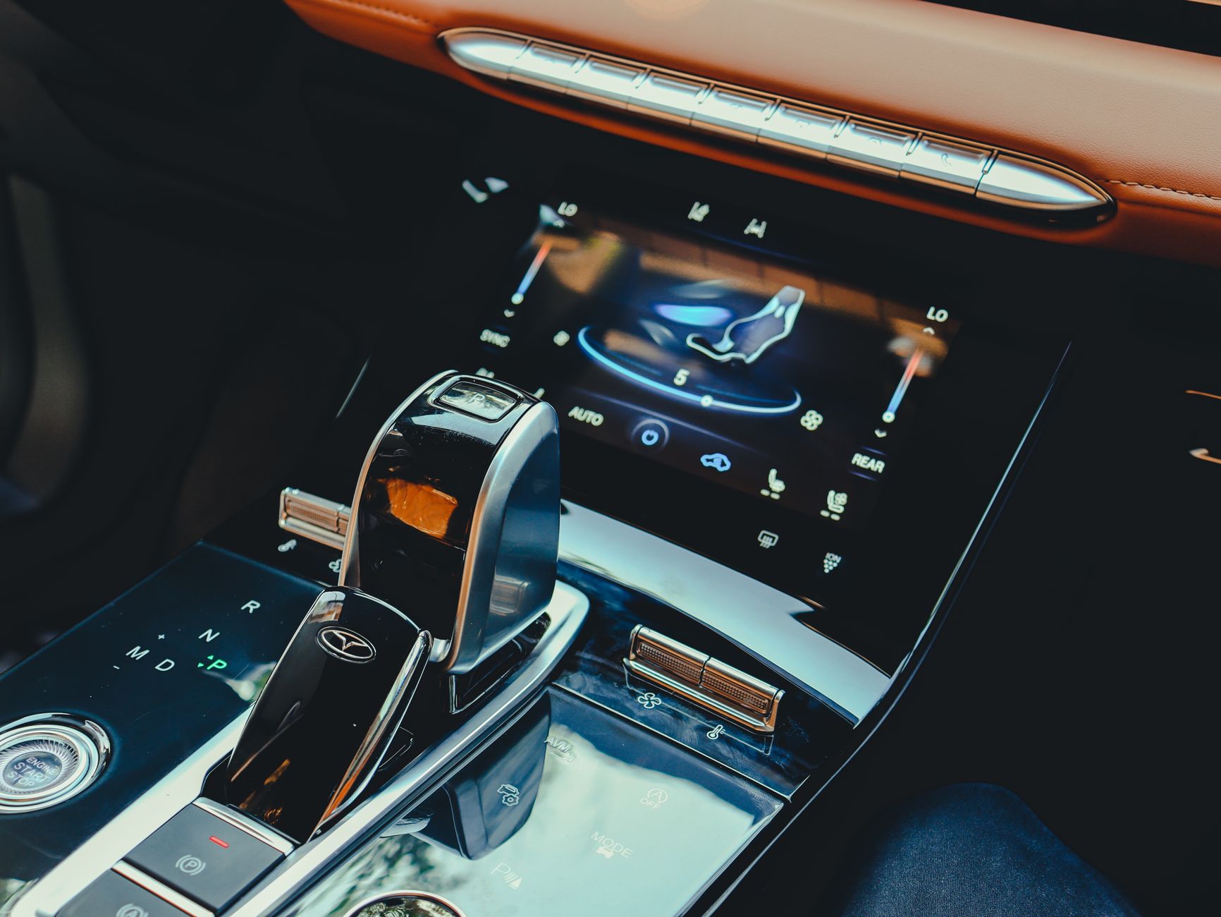 Sleek car interior featuring advanced center console and digital display for a high-tech driving experience.
