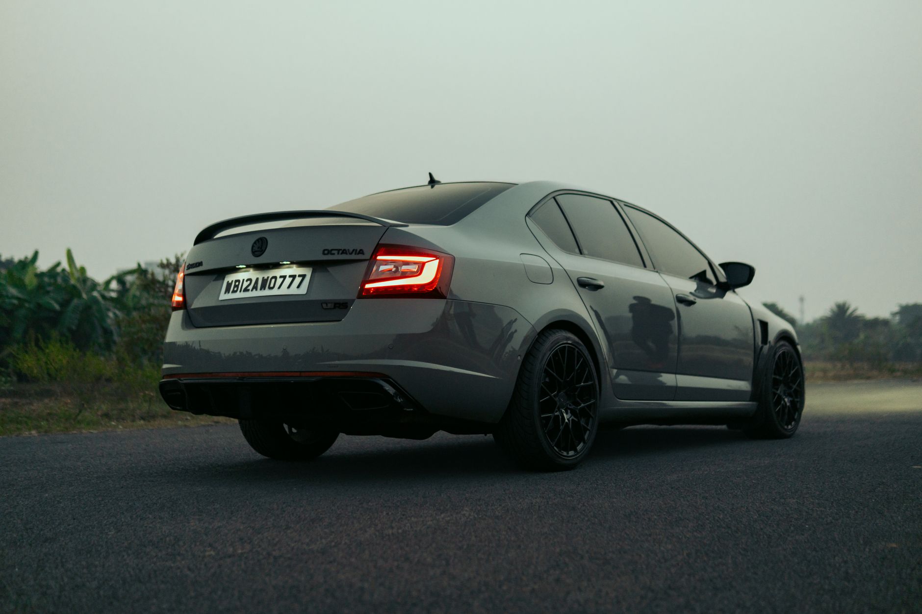 Modern grey Skoda Octavia parked on a serene Indian road, showcasing its sleek design and style.