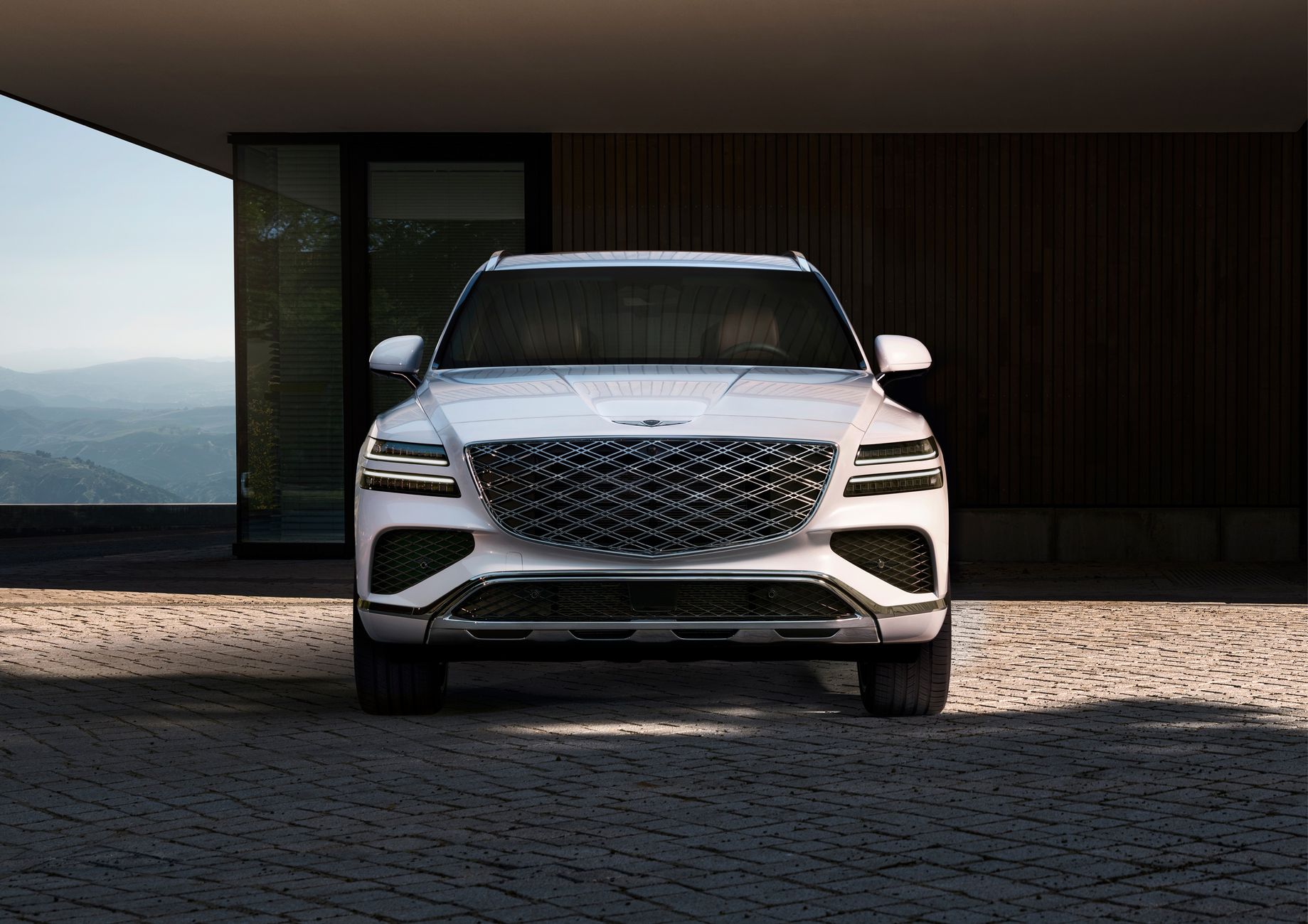 A sleek white SUV parked in front of a contemporary building, exuding luxury and style.