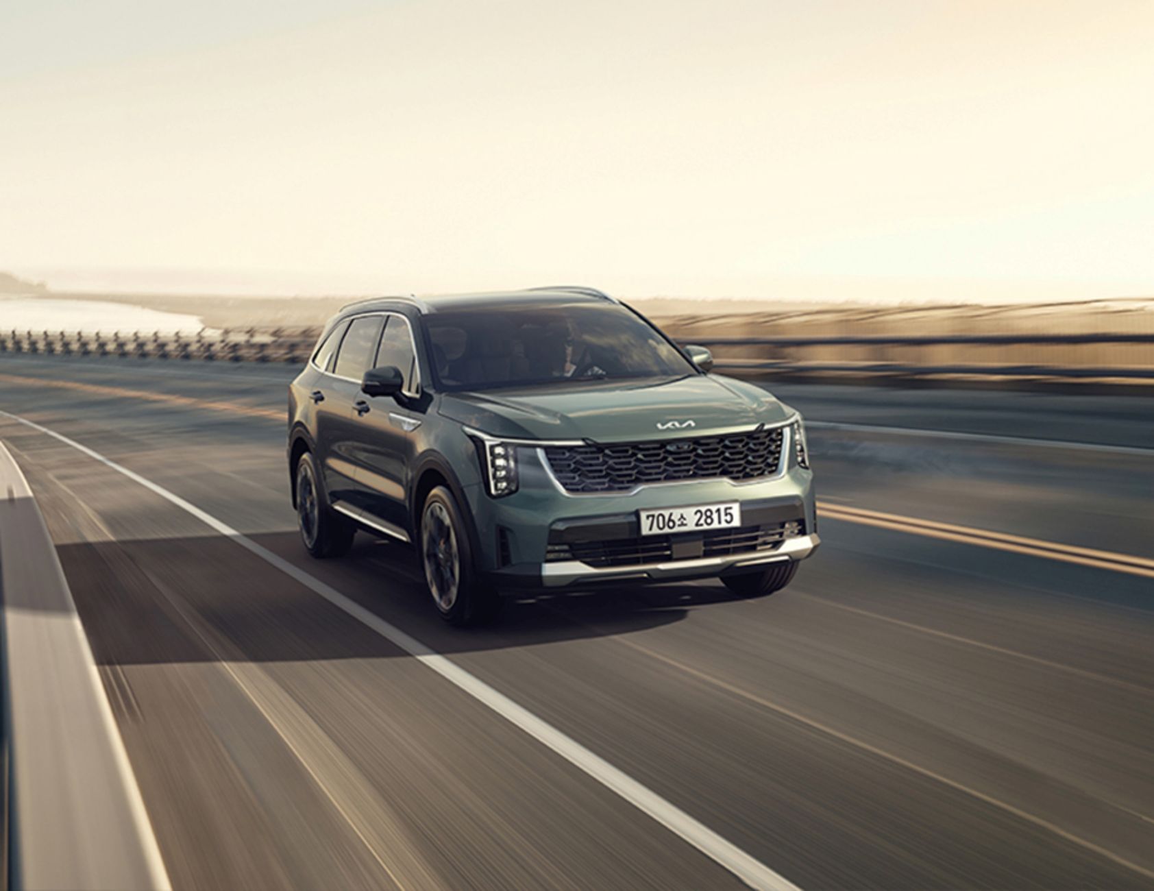 Kia Sorento SUV driving on a coastal road, capturing the essence of mobility and adventure.