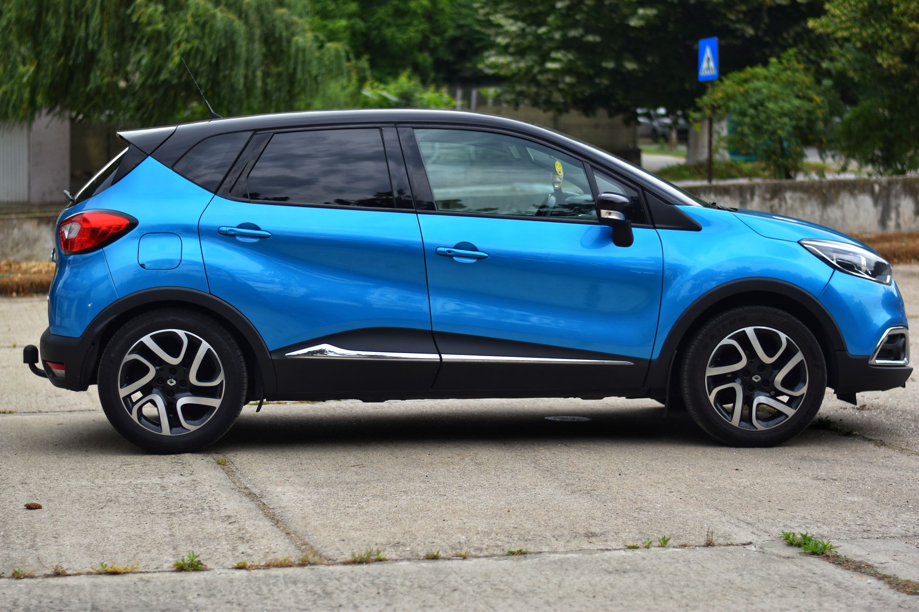 A bright blue compact SUV parked on concrete, perfect for lifestyle and travel imagery.